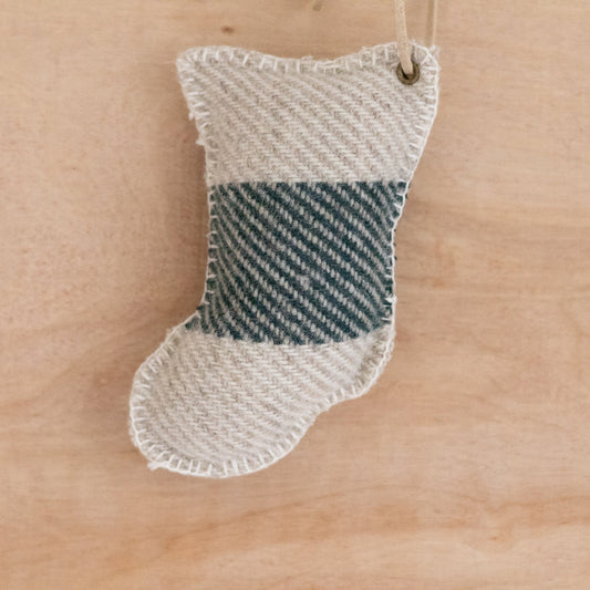 Textured stocking ornament on a wooden surface