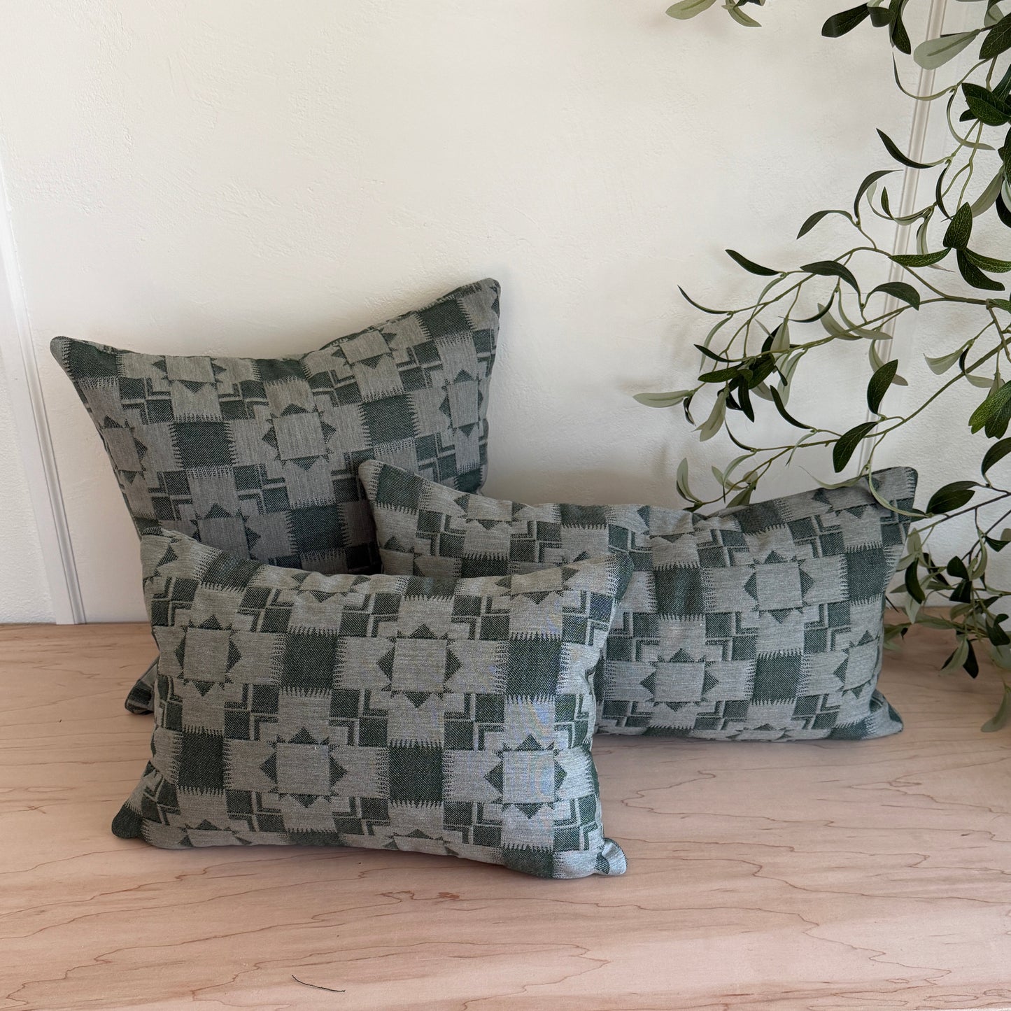 Patterned cushions on a wooden surface with a light background