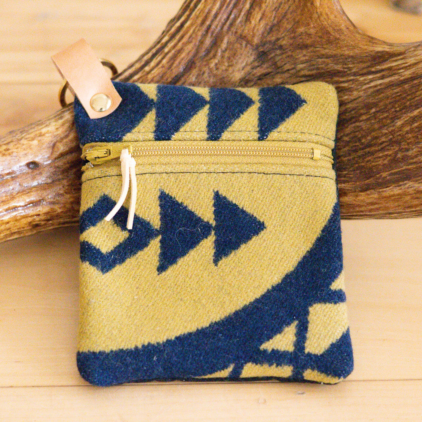 Small pouch with blue and yellow pattern on a wooden surface
