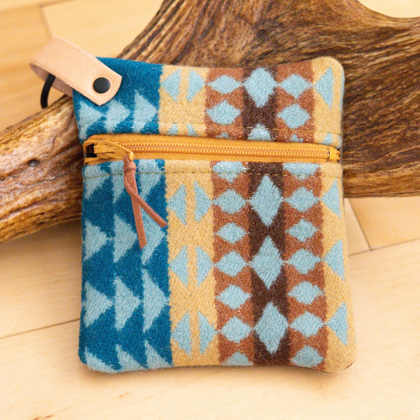 Patterned pouch with a zipper on a wooden surface