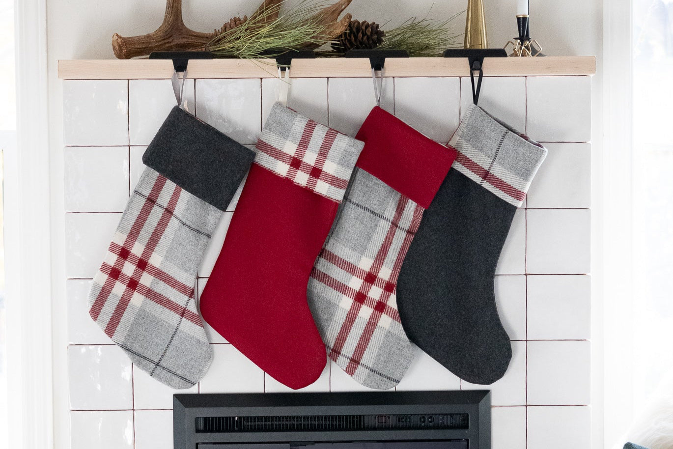 Christmas stockings hanging above a fireplace with a cozy living room setting.