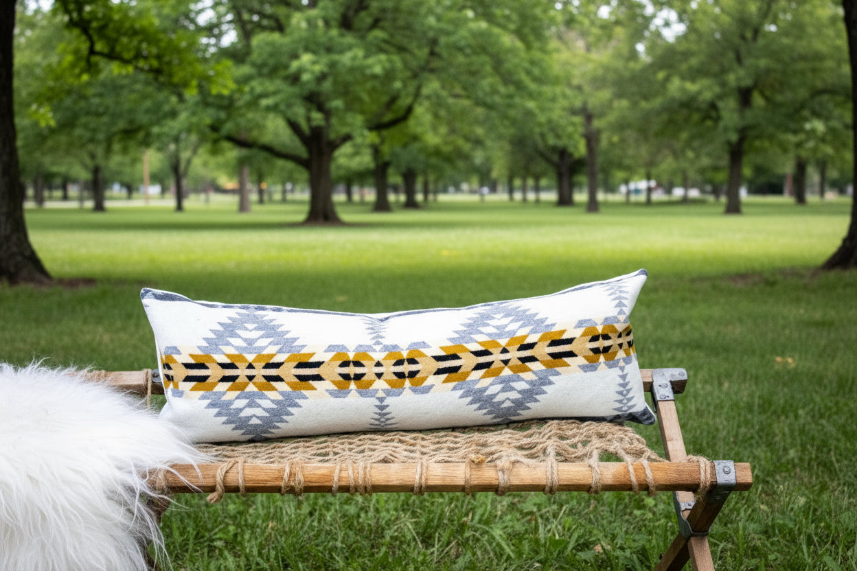 Decorative pillow with geometric pattern on a woven bench