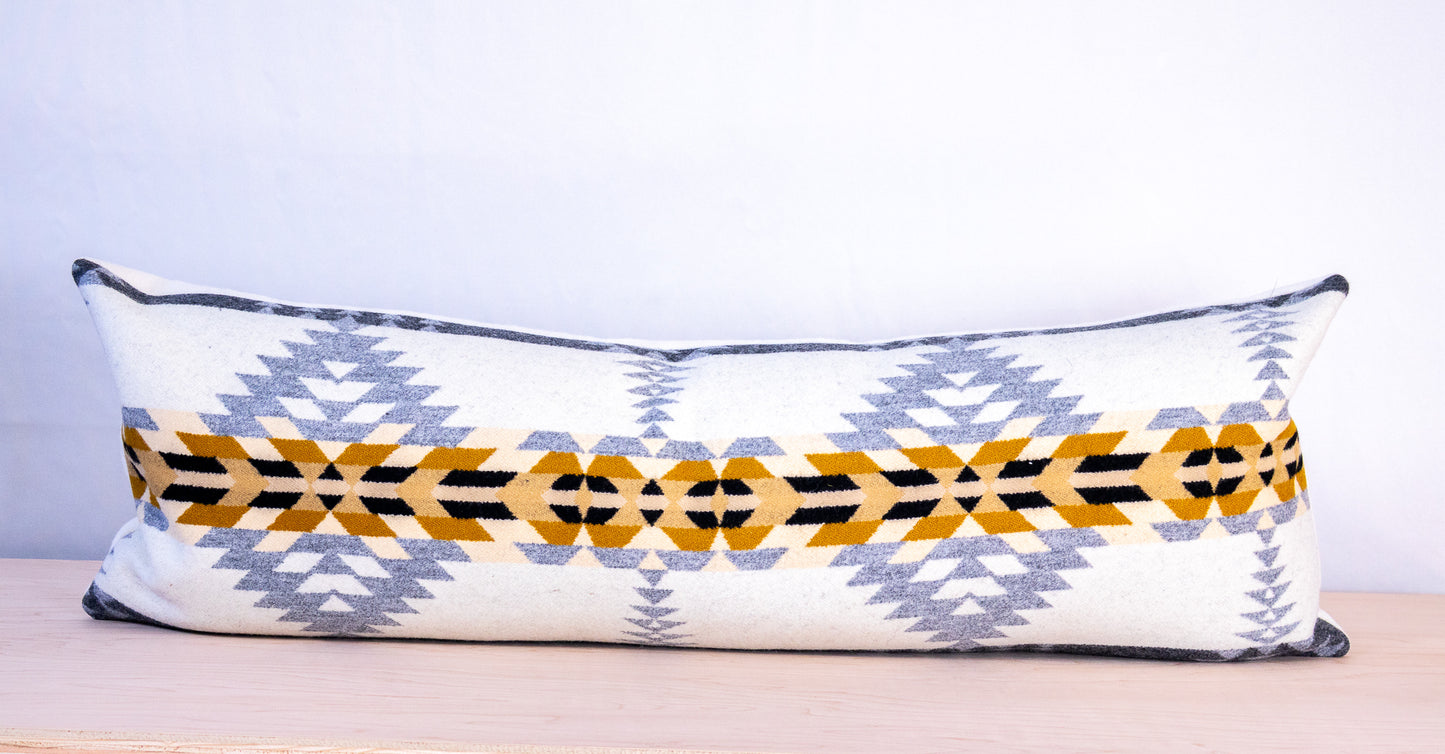 Decorative pillow with geometric pattern on a plain background