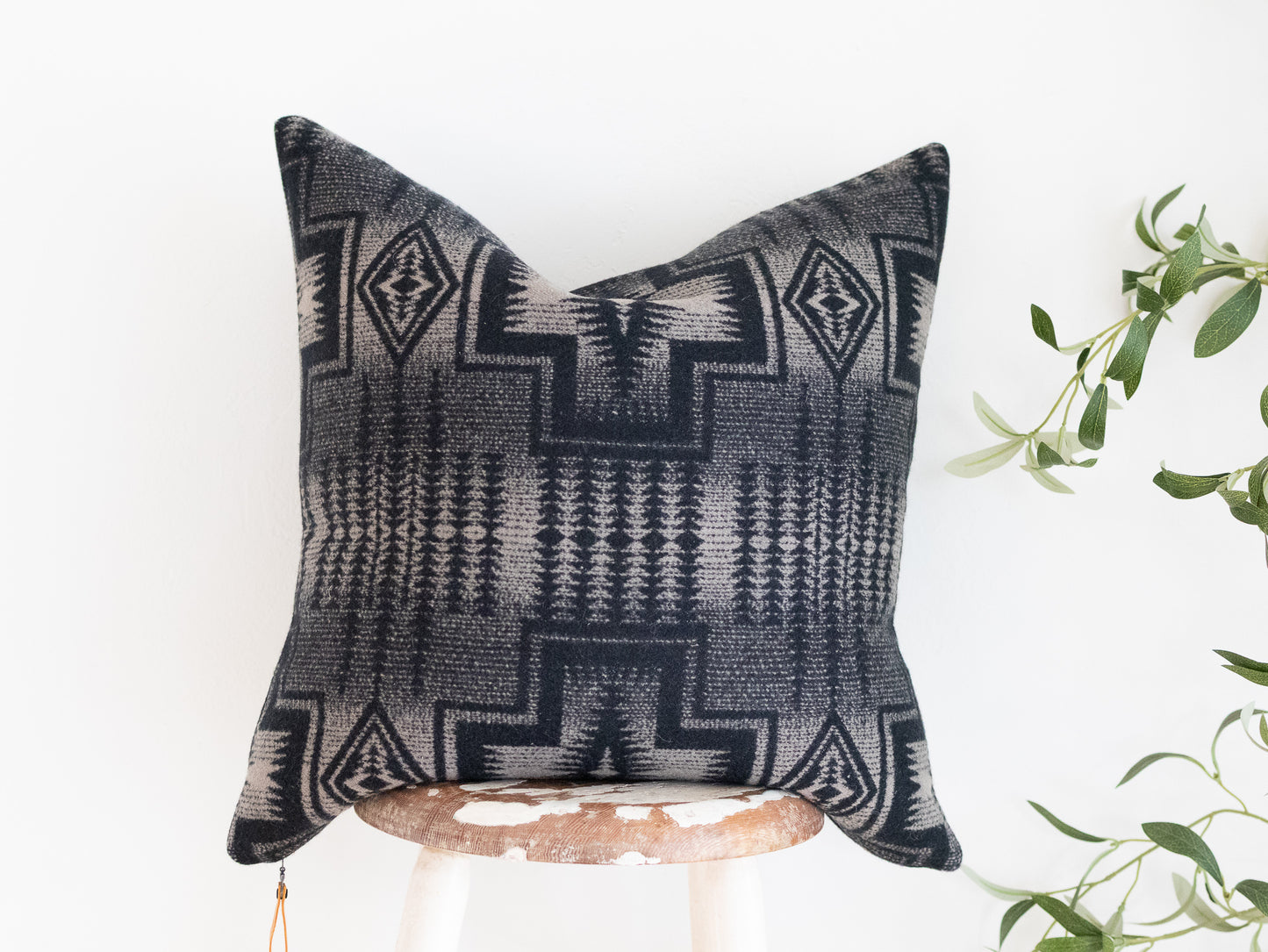 Decorative black and tan pillow with geometric pattern