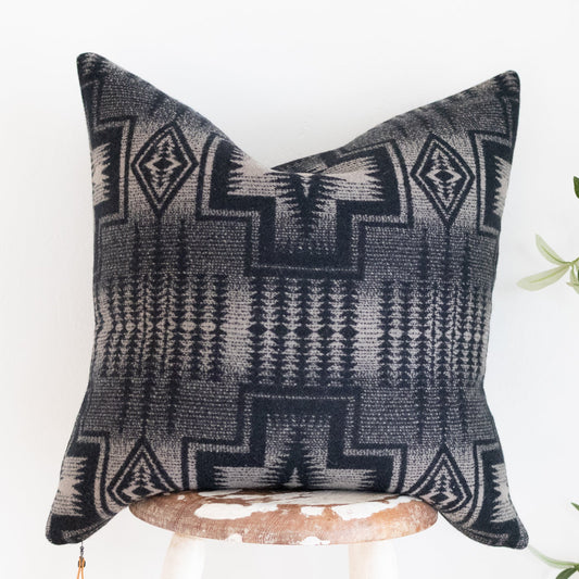 Decorative black and tan pillow with geometric pattern