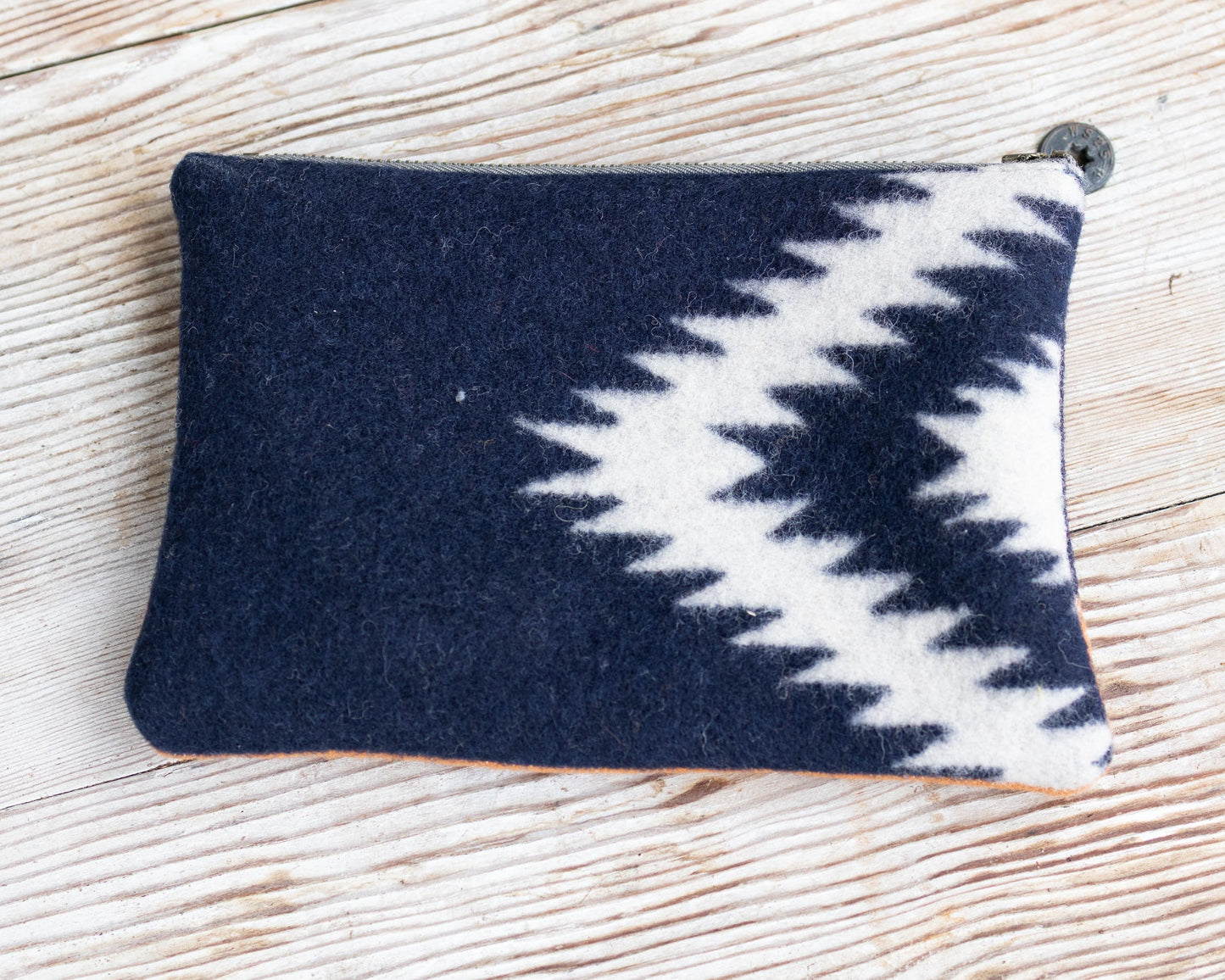 Navy blue and white patterned pouch on a wooden surface