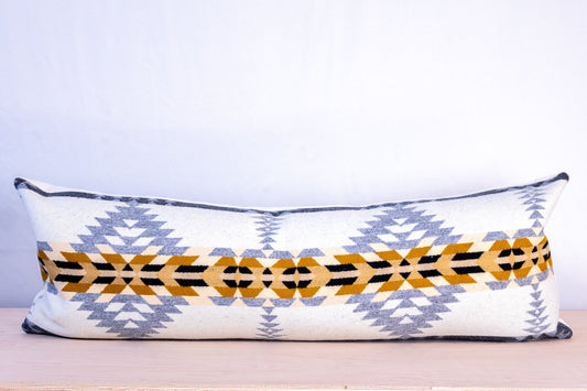 Decorative pillow with geometric pattern on a light background
