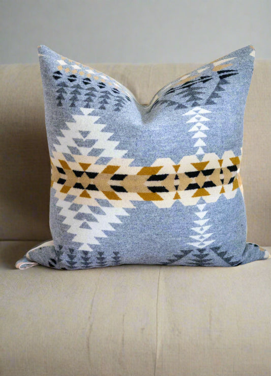 Decorative pillow with geometric pattern on a brown surface