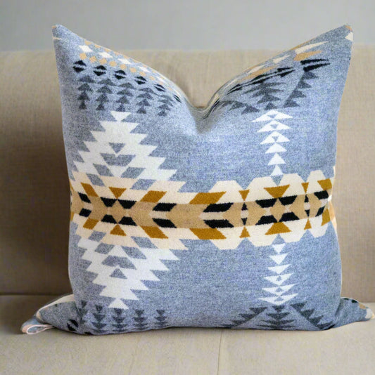 Decorative pillow with geometric pattern on a brown surface