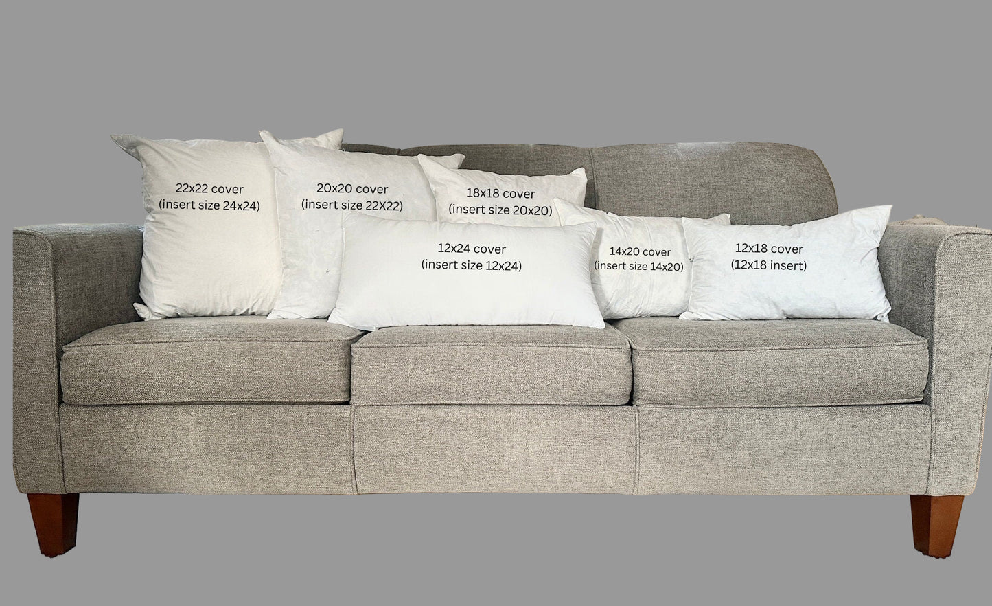 Gray sofa with white pillows displaying text about cover sizes.