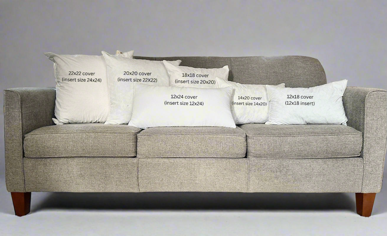 Gray sofa with white pillows displaying text about cover sizes.