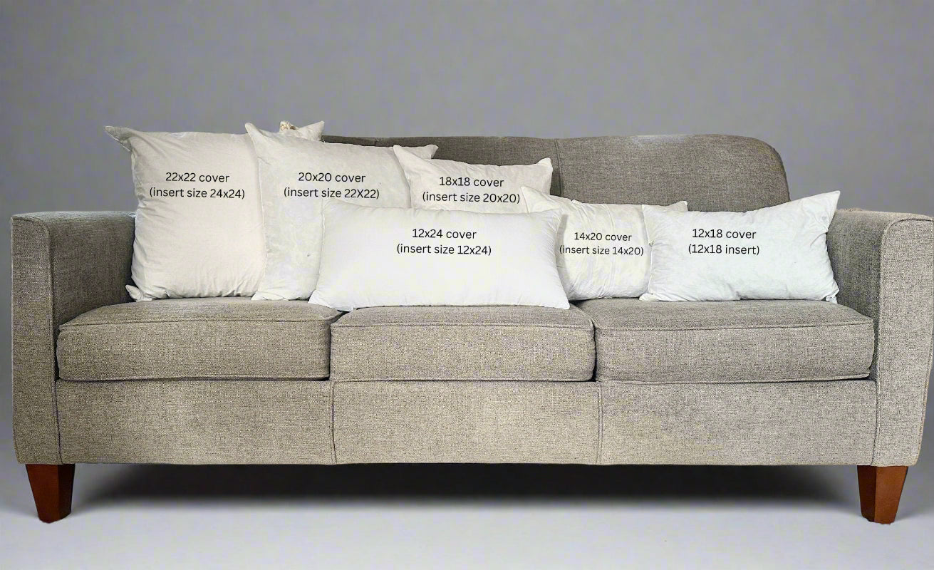 Gray sofa with white pillows displaying text about cover sizes.