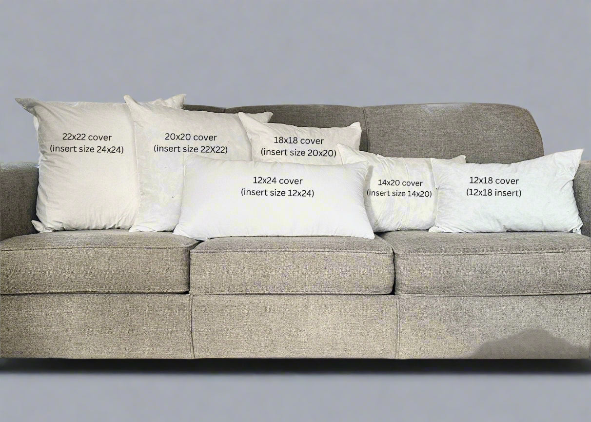 Gray sofa with decorative pillows of various sizes in a living room setting.