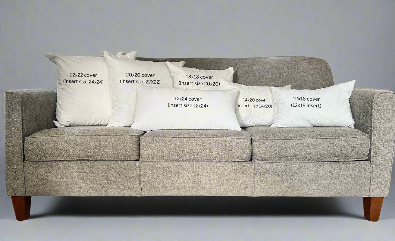 Gray sofa with white pillows displaying text about cover sizes.