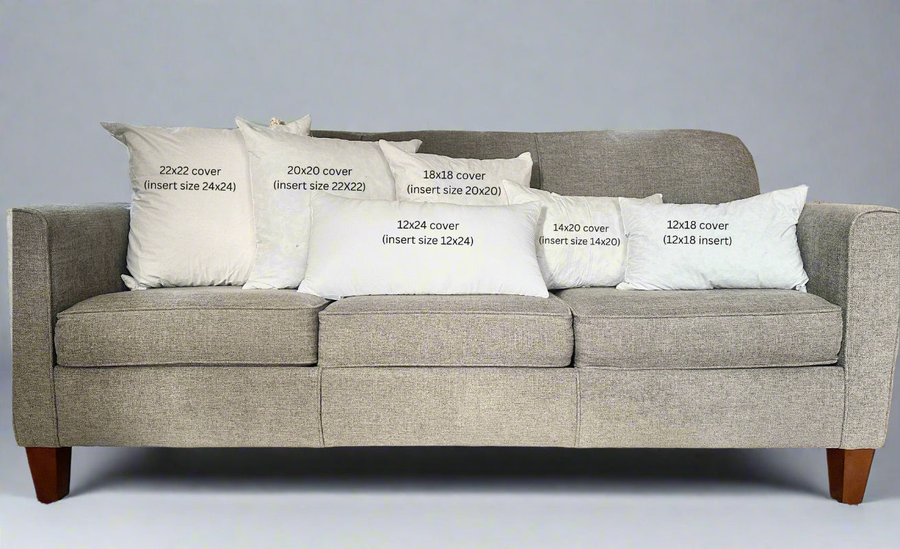 Gray sofa with white pillows displaying text about cover dimensions.