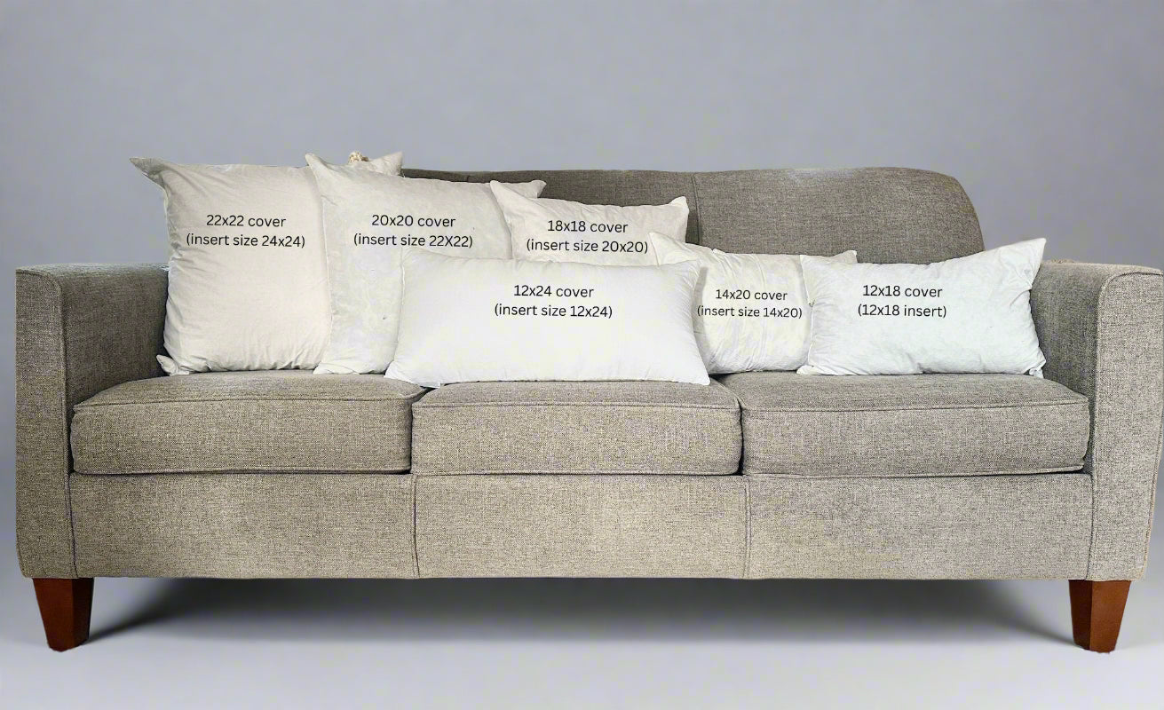 Gray sofa with white pillows displaying text about cover sizes.