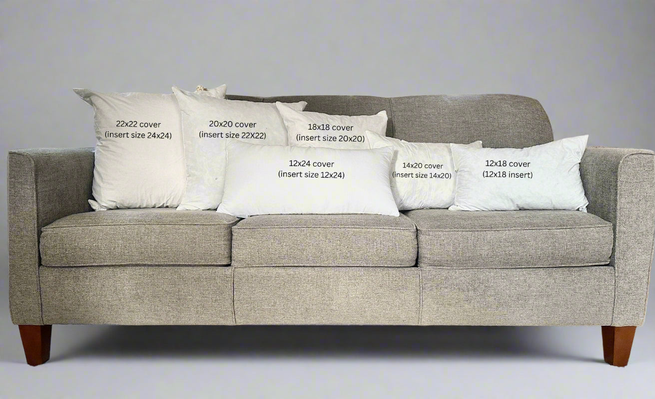 Gray sofa with white pillows displaying text about cover sizes.