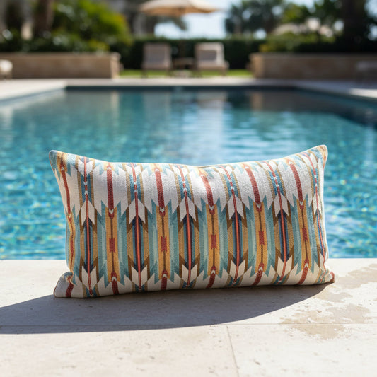 Decorative pillow with tribal pattern on a poolside ledge