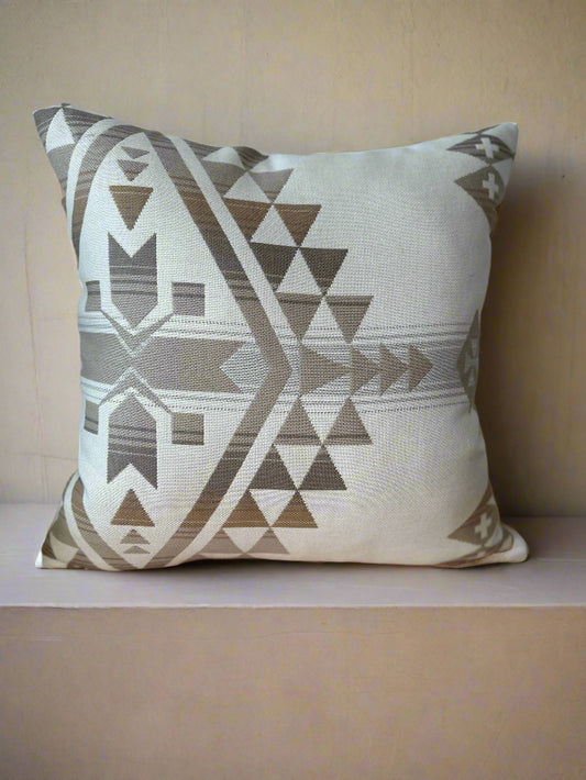 Decorative pillow with geometric pattern on a wooden surface