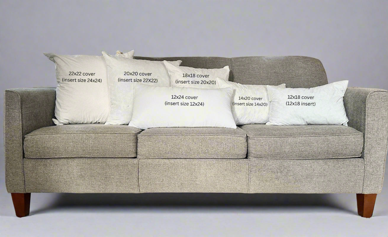 Gray sofa with white pillows displaying text about cover sizes.