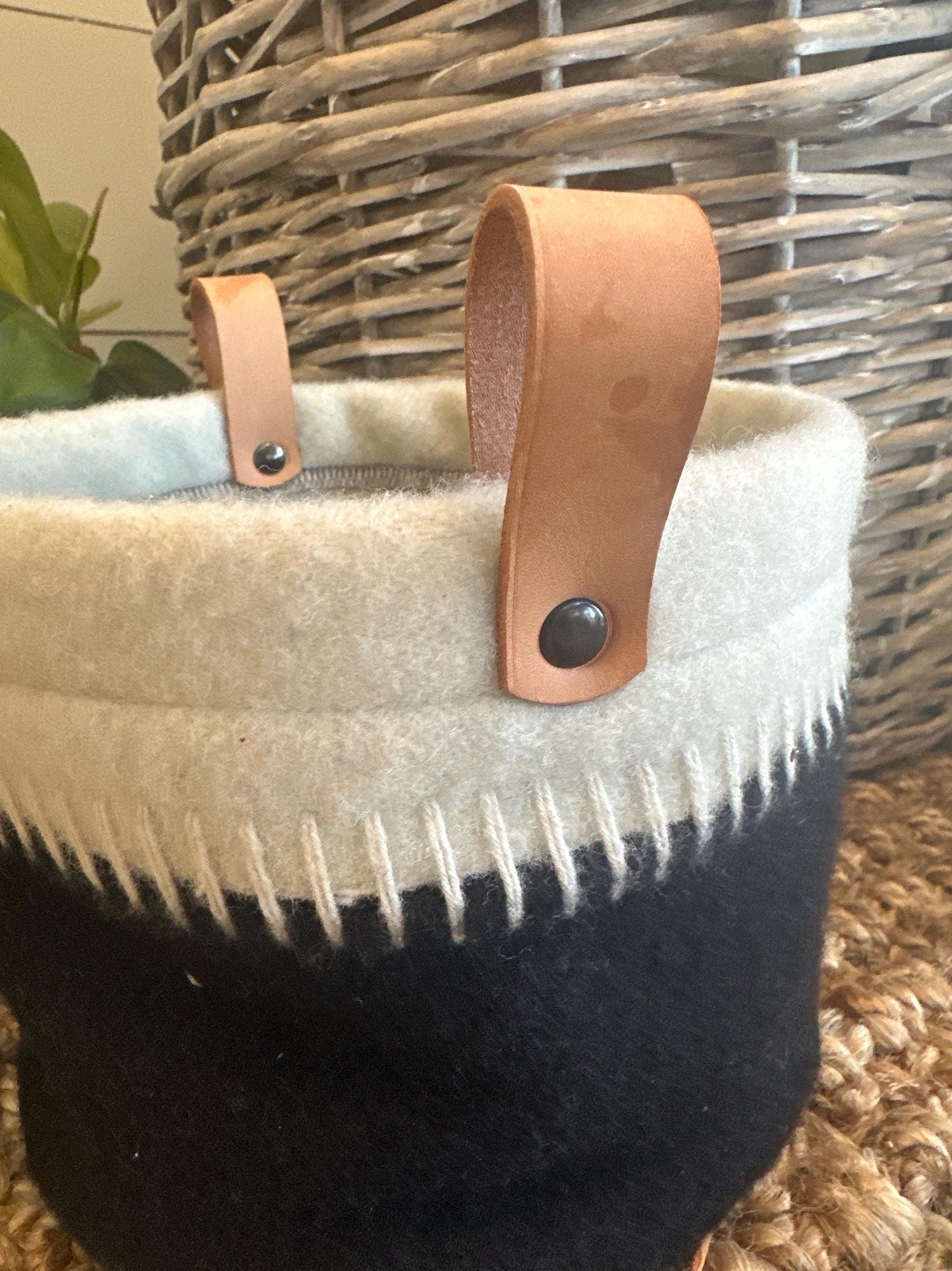 Basket with a leather handle and white and black patterned fabric