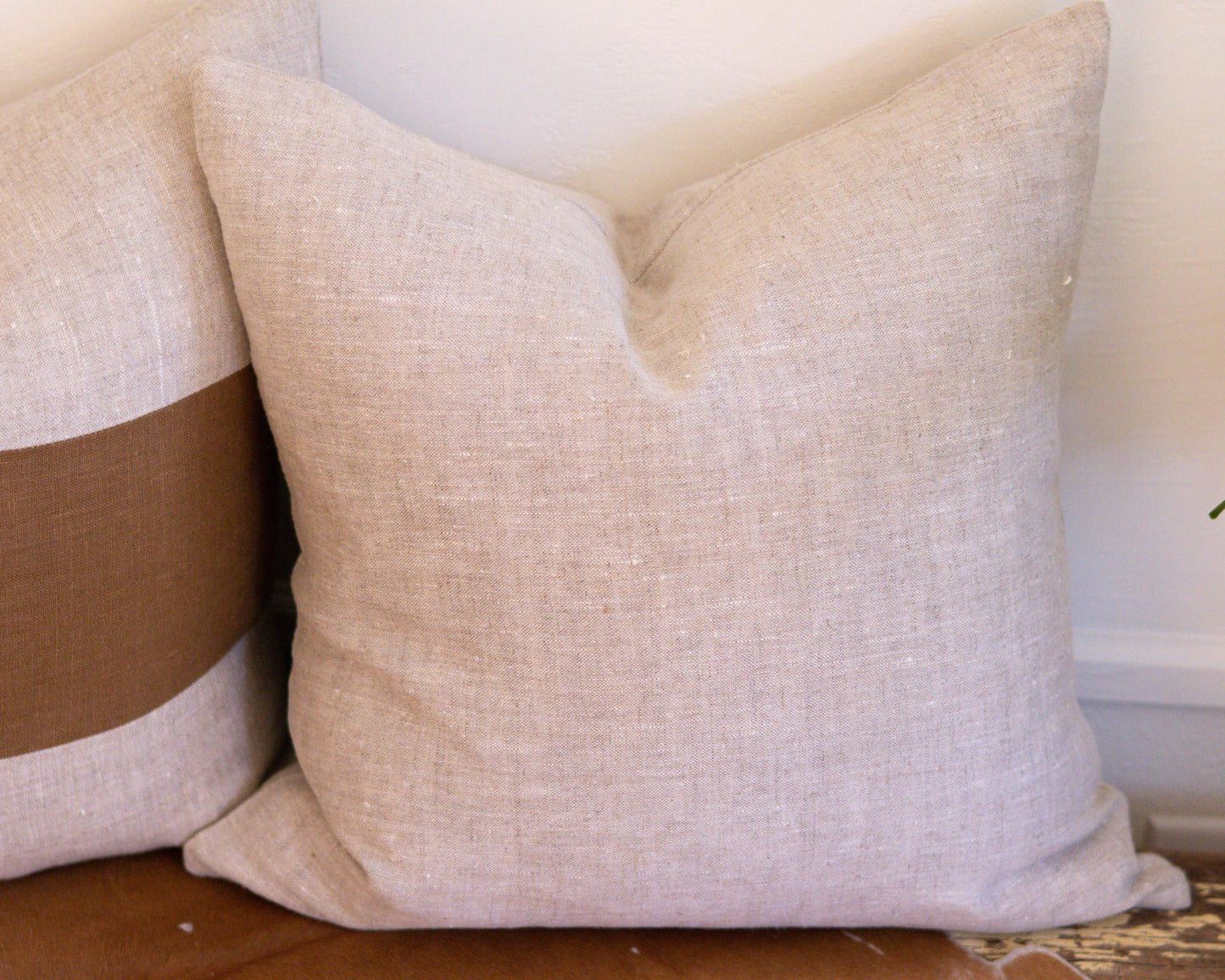 Textured linen pillow on a wooden surface with a neutral background