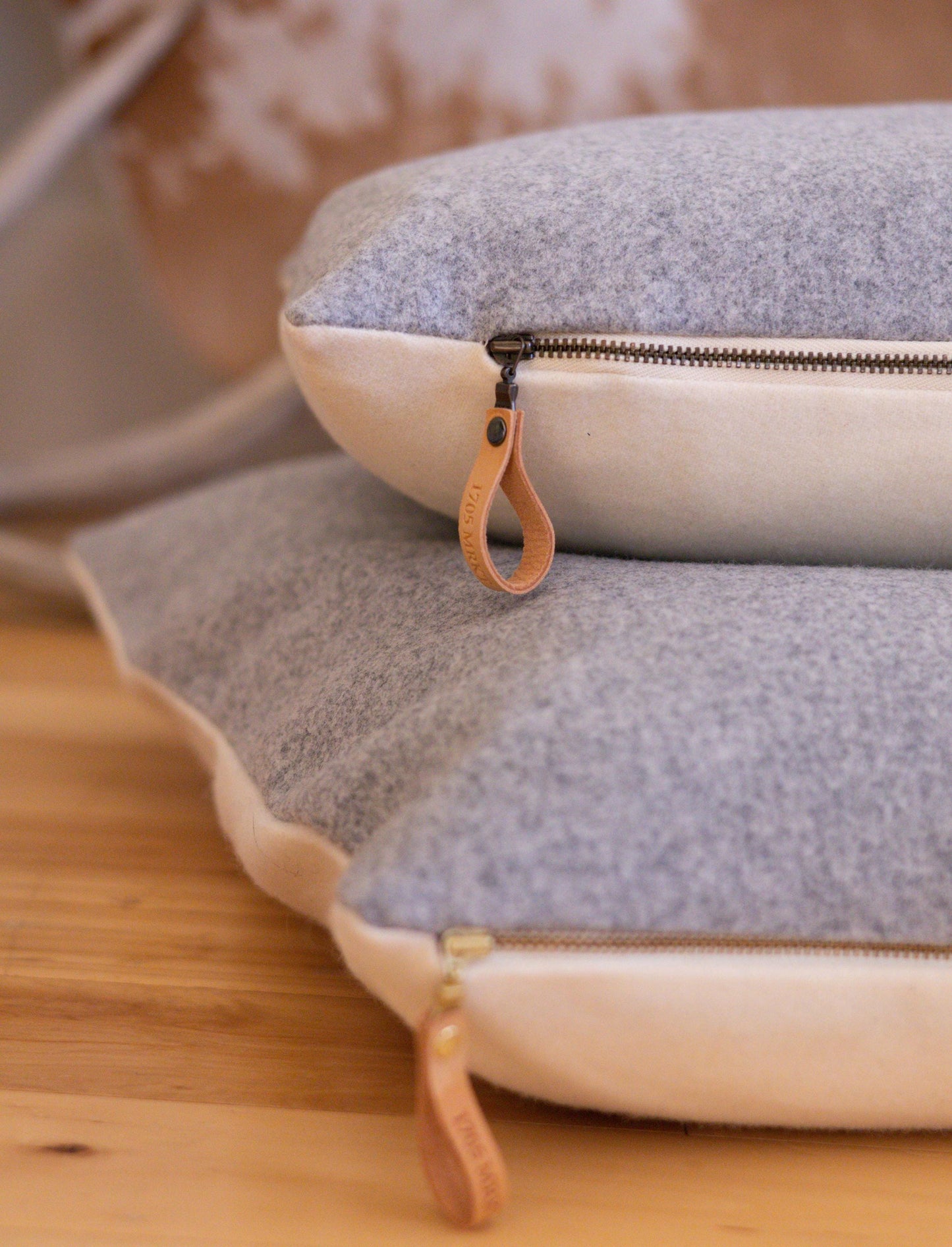 Close-up of a textured pouch with a zipper on a wooden surface