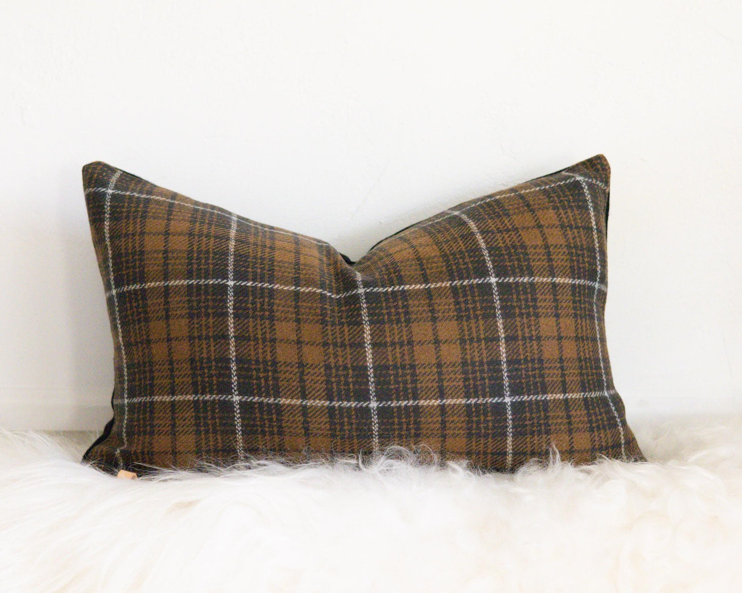 Plaid pillow on a white surface