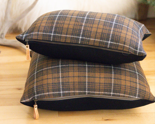Plaid patterned pillow on a wooden surface