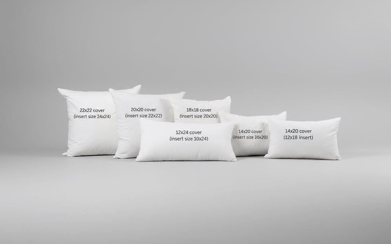 Gray sofa with decorative pillows labeled for size on a carpeted floor.