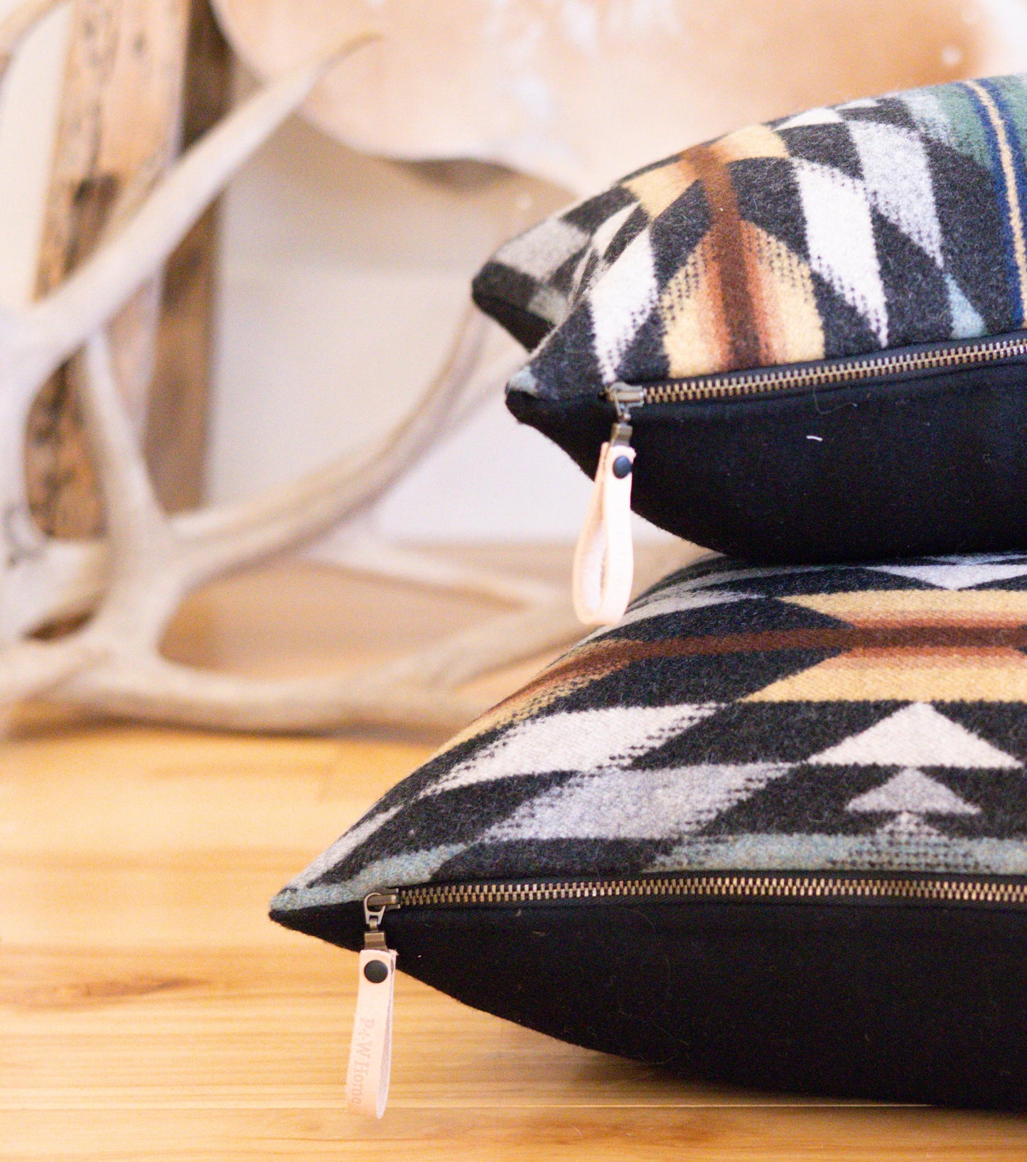 Patterned pillows with zippers on a wooden surface