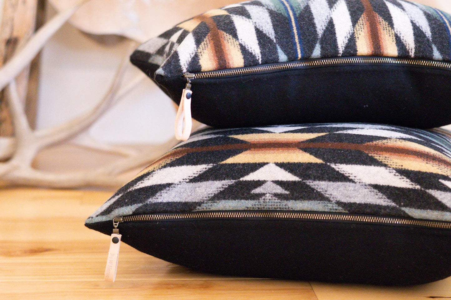 Patterned cushions with zippers on a wooden surface