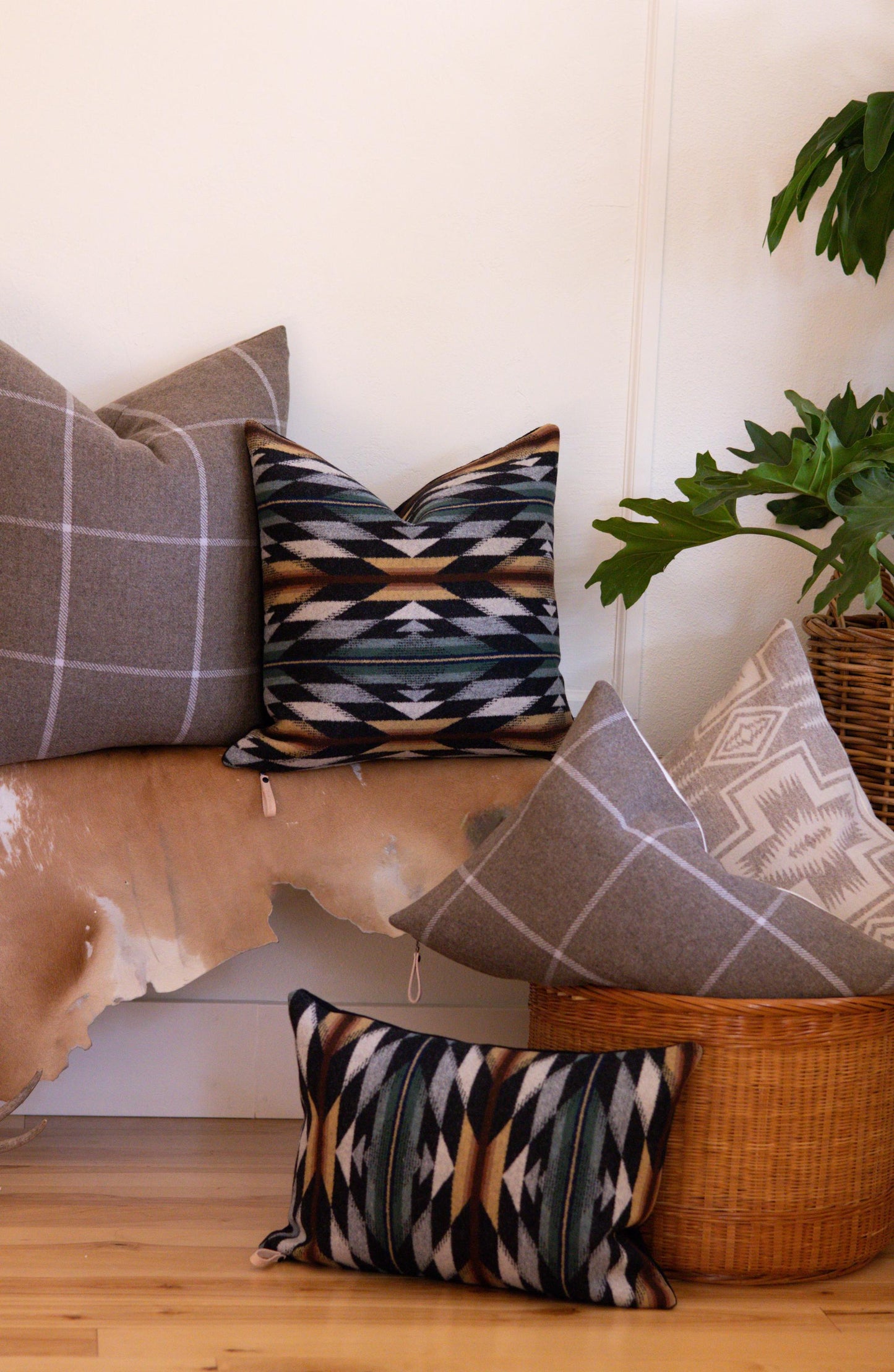 Decorative pillows with geometric patterns on a wooden surface