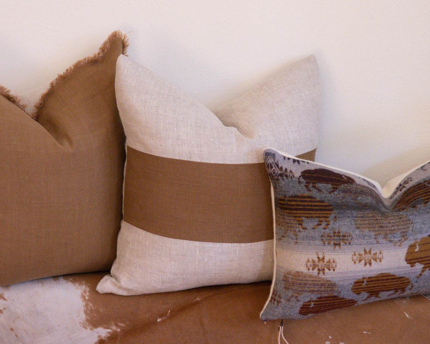 Decorative pillows on a sofa with a neutral background