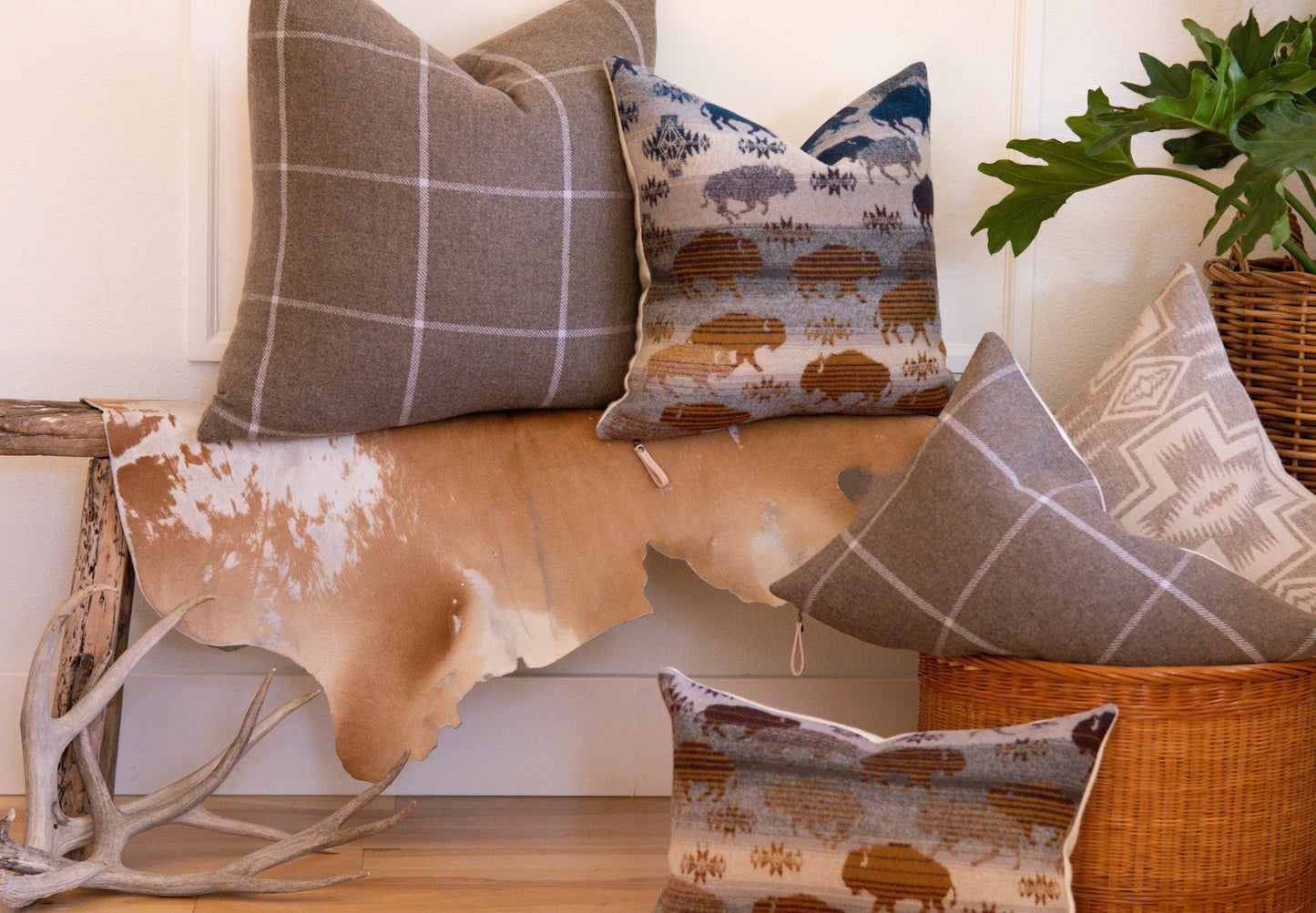 Decorative pillows with different patterns on a wooden surface.