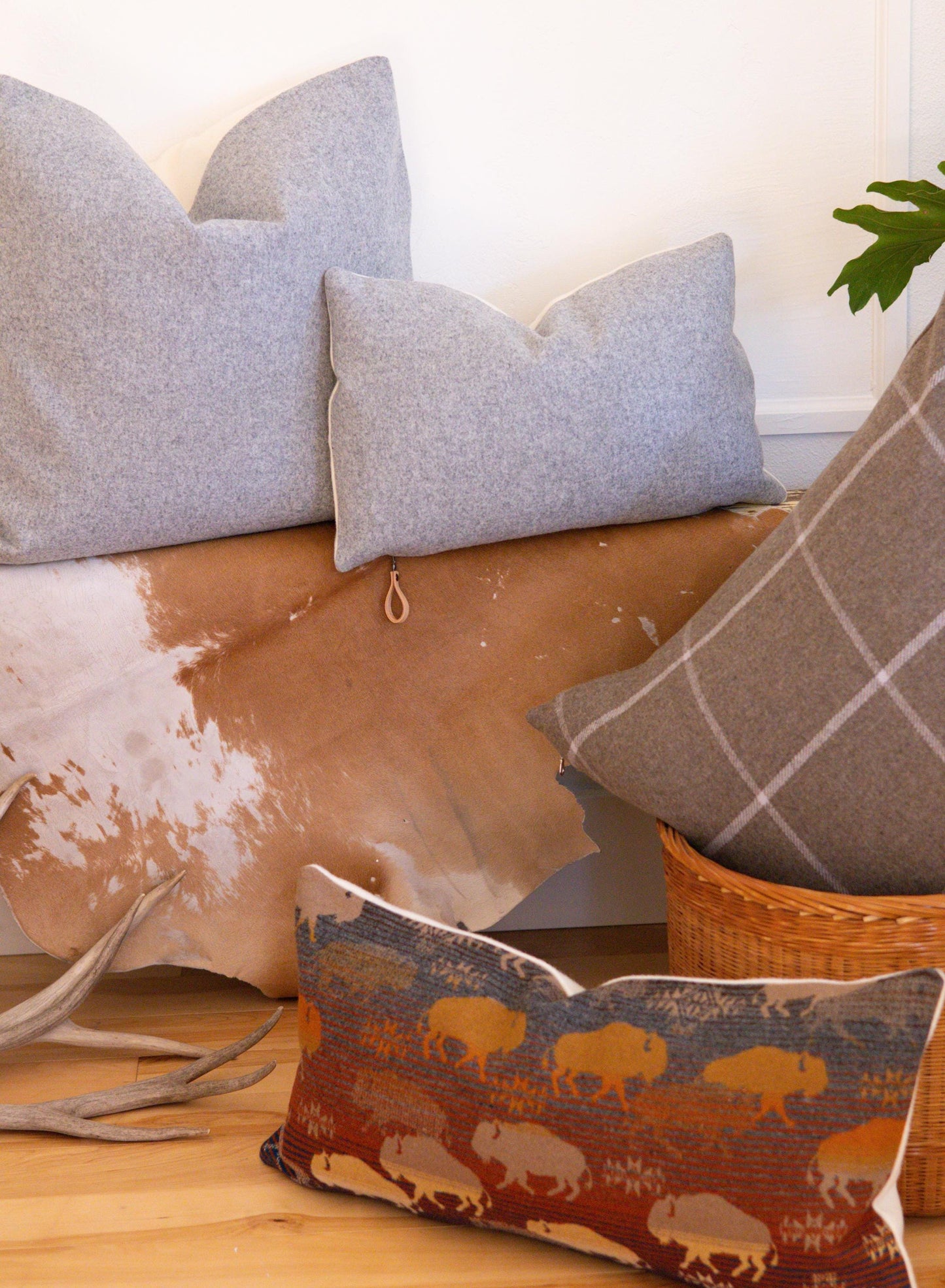 Decorative pillows on a couch with a patterned pillow featuring bison.