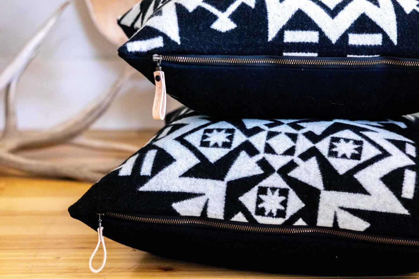 Black and white patterned pillows on a wooden surface