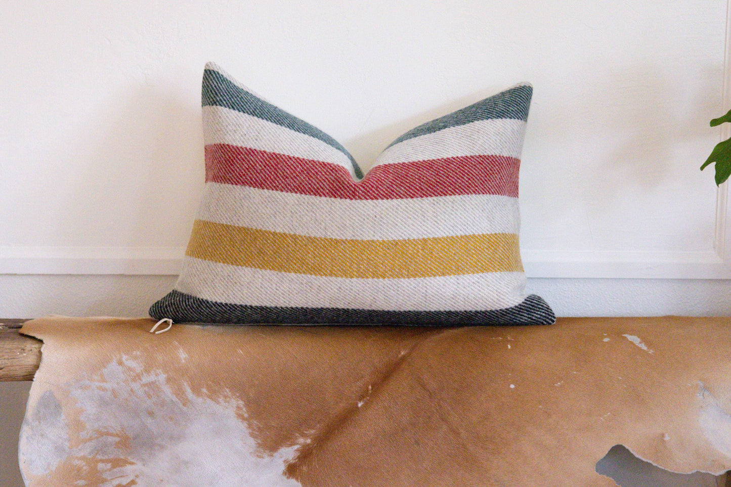 Striped pillow on a wooden surface with a white background