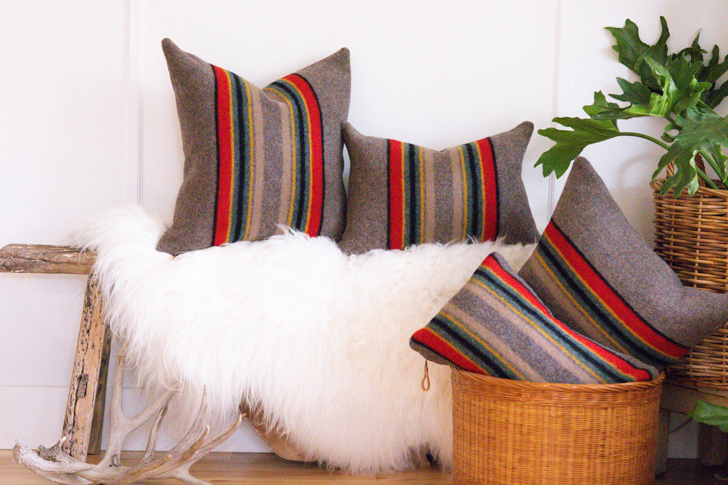 Decorative pillows with striped patterns on a white wall background
