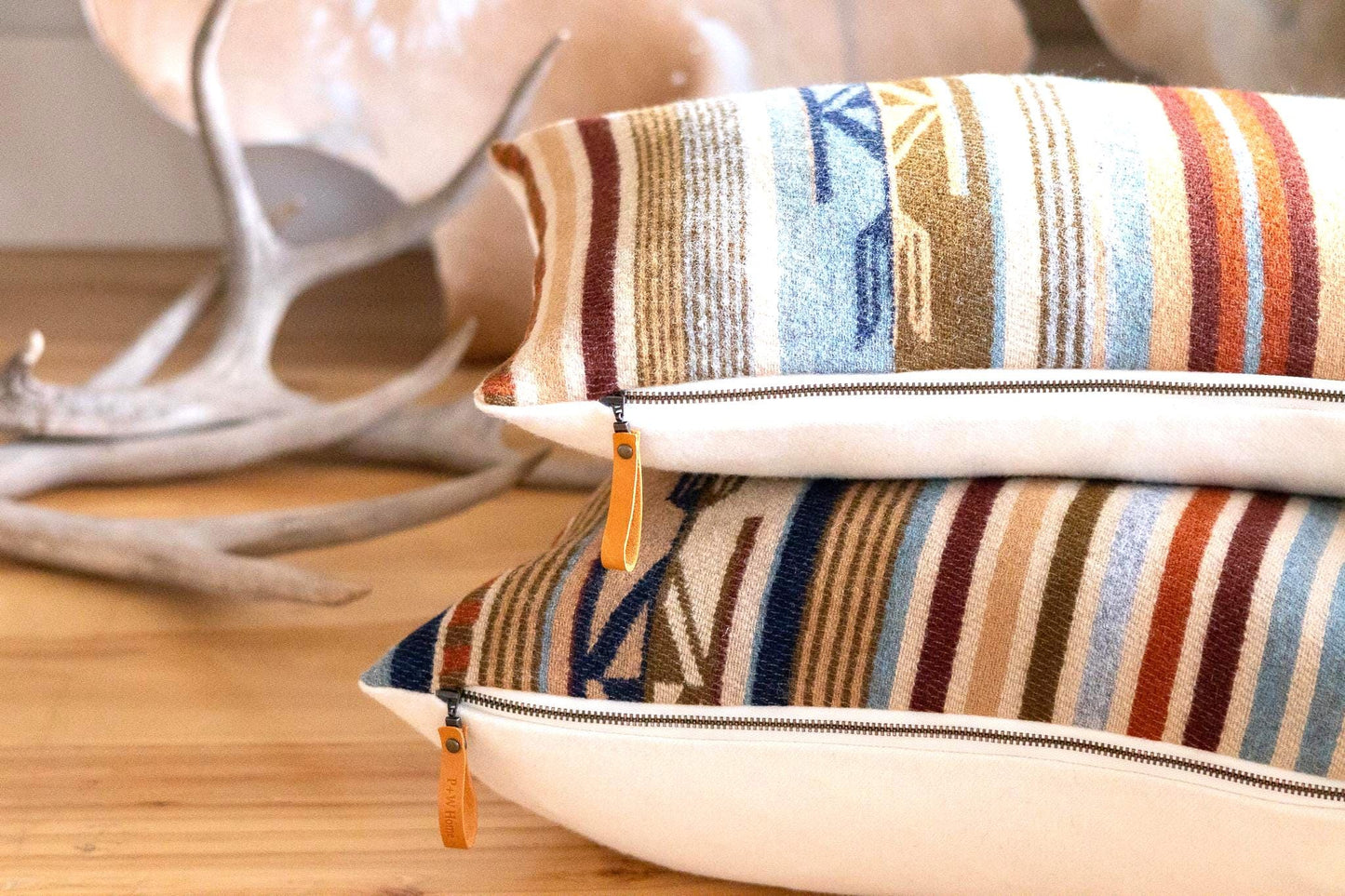 Striped pillows with decorative tassels on a wooden surface
