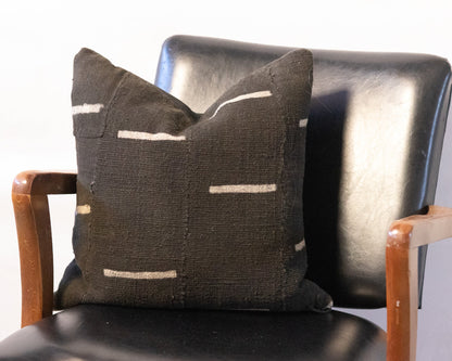 Decorative pillow with geometric pattern on a black chair