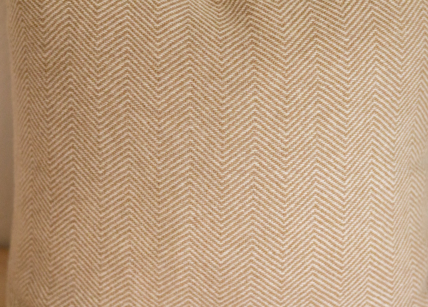 Close-up of a textured fabric with a herringbone pattern.