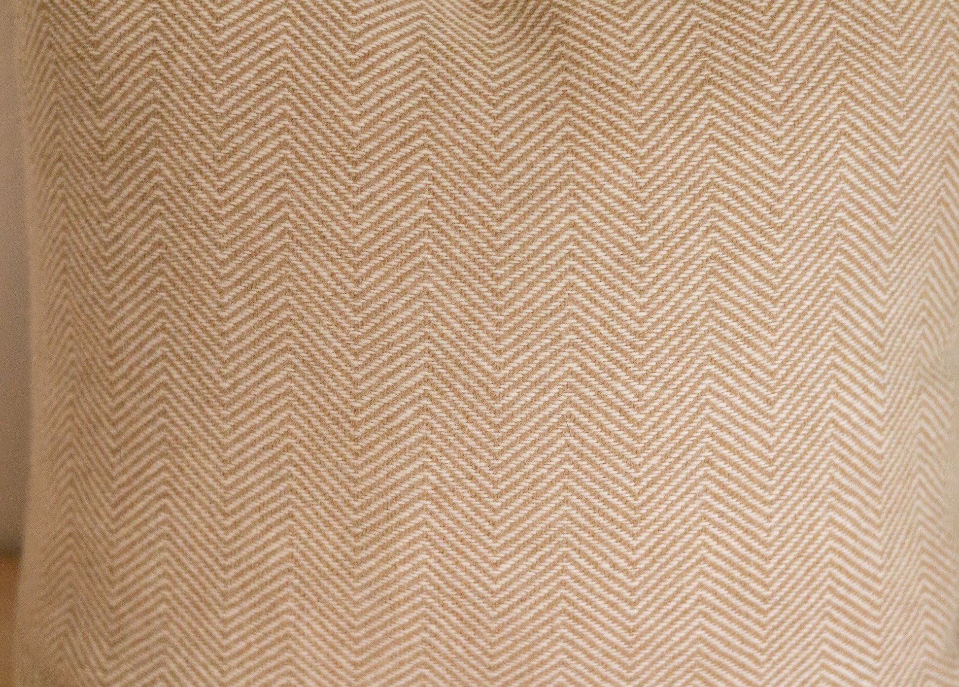 Close-up of a textured fabric with a herringbone pattern.