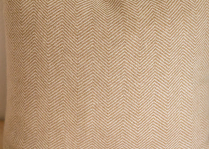 Close-up of a textured fabric with a herringbone pattern.