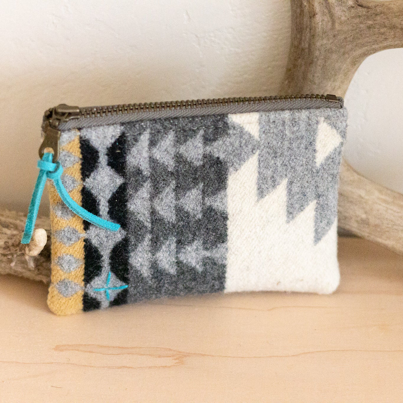 Small pouch with a geometric pattern on a wooden surface