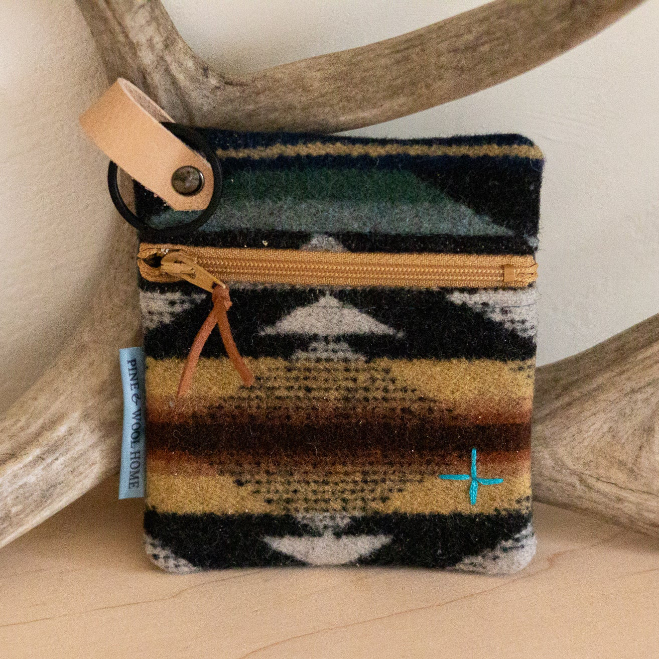 Small pouch with a patterned design on a wooden surface