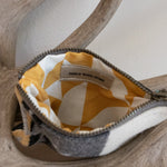 Small pouch with a geometric pattern on a wooden surface