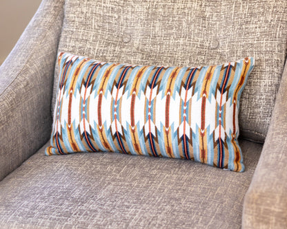 Decorative pillow with geometric pattern on a gray sofa