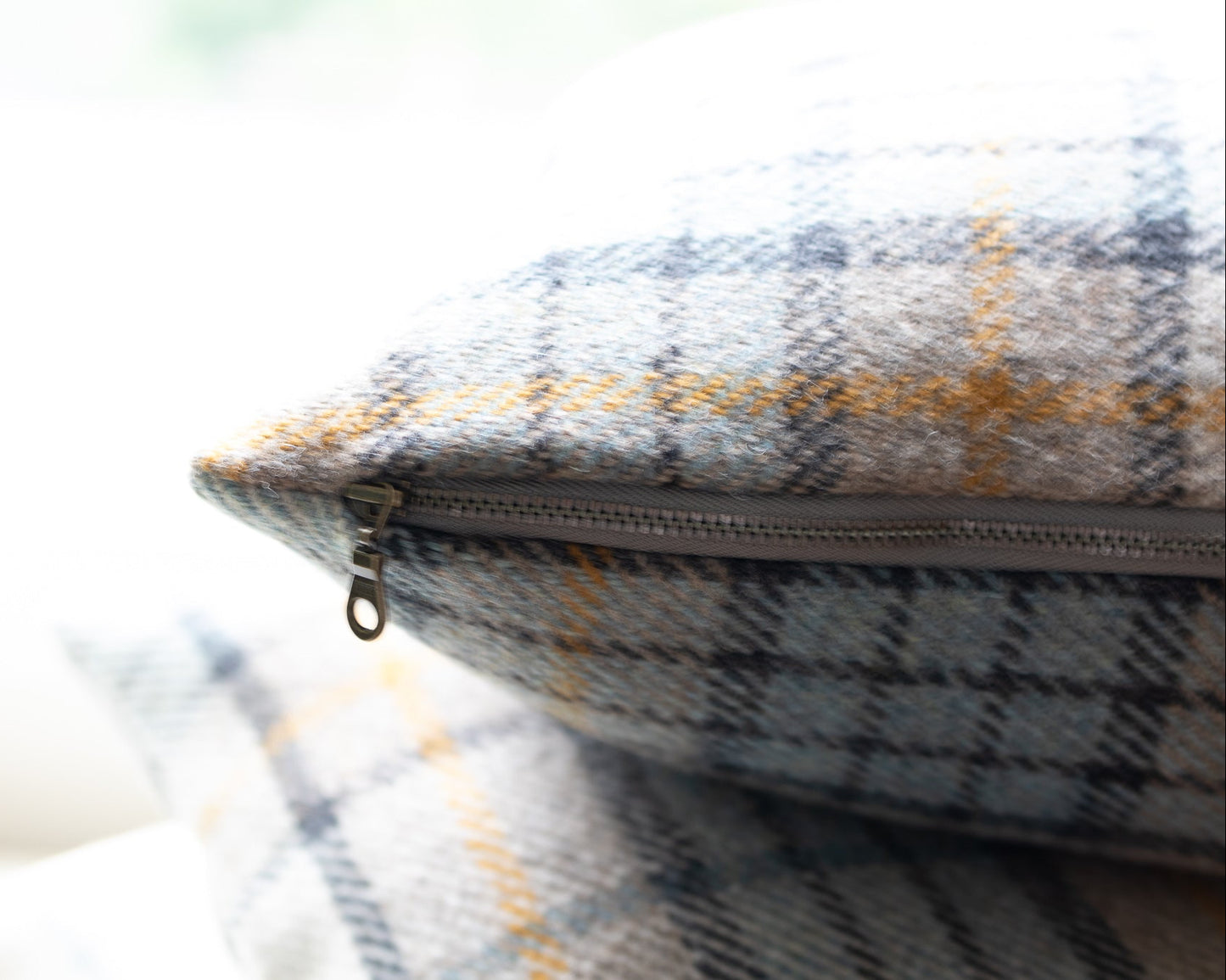 Plaid patterned pouch with a zipper on a blurred background