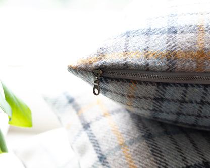 Plaid-patterned pillow  with a zipper on a light background